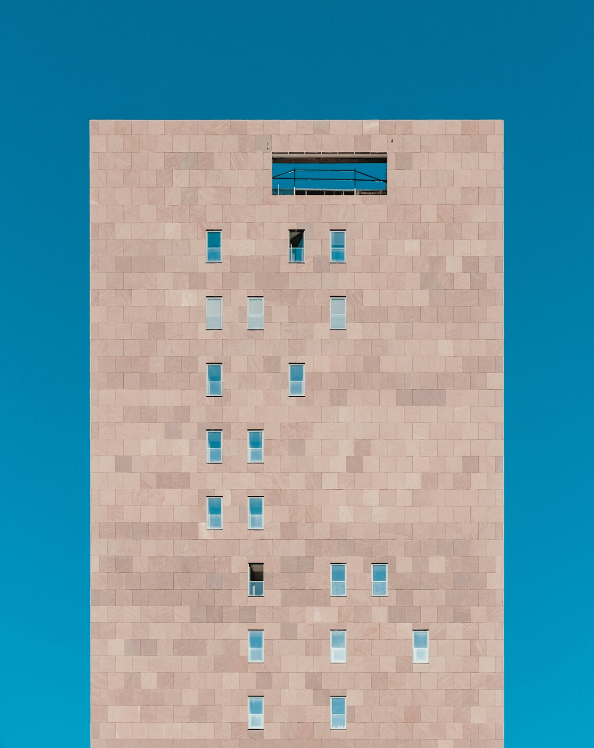 white framed window on brown concrete wall