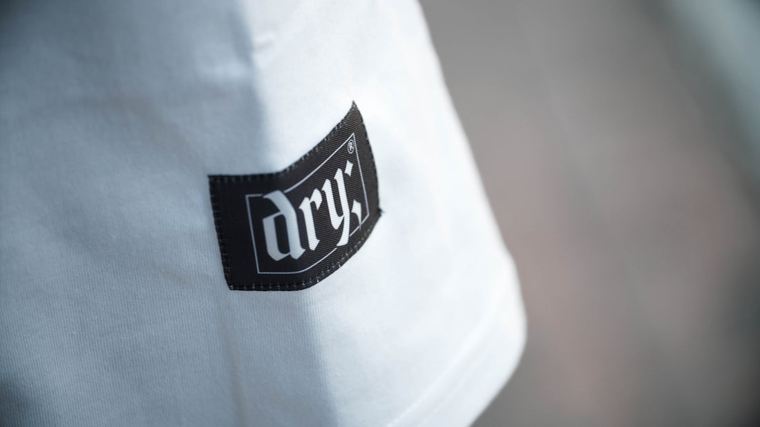 a close up of a logo on a white shirt