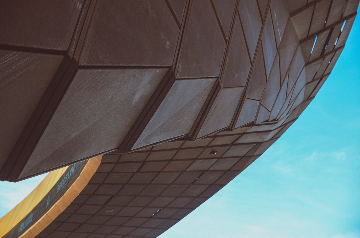 a close up of a building with a sky in the background