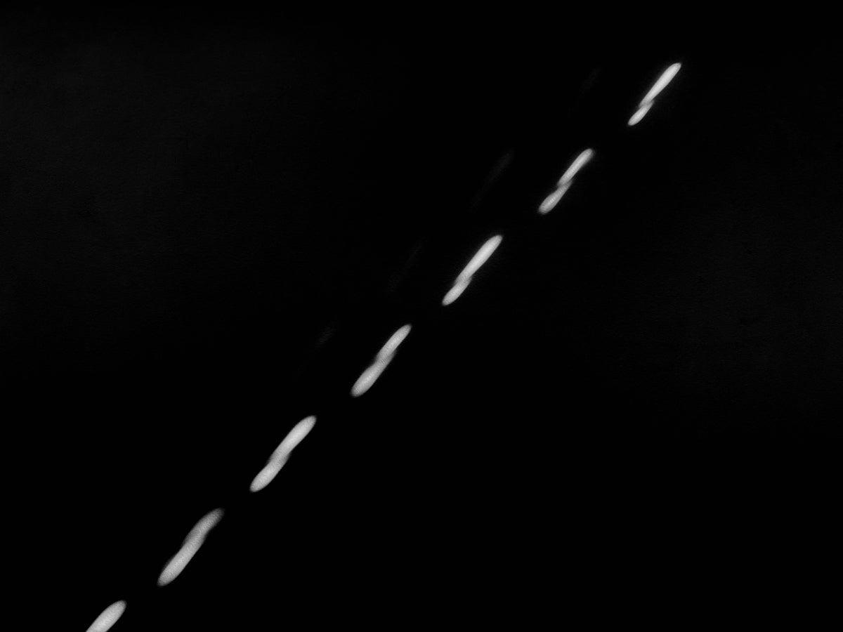 a black and white photo of a street light