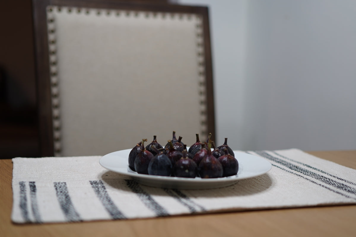a white plate topped with figurines on top of a wooden table