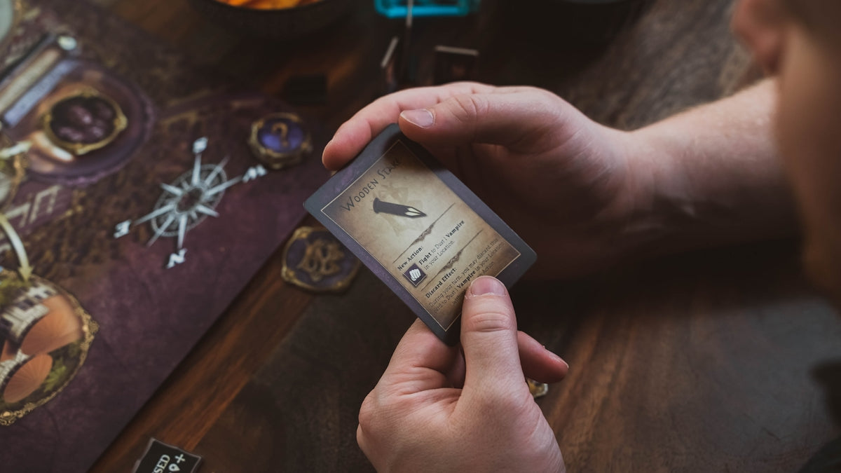 a person holding a card on top of a table