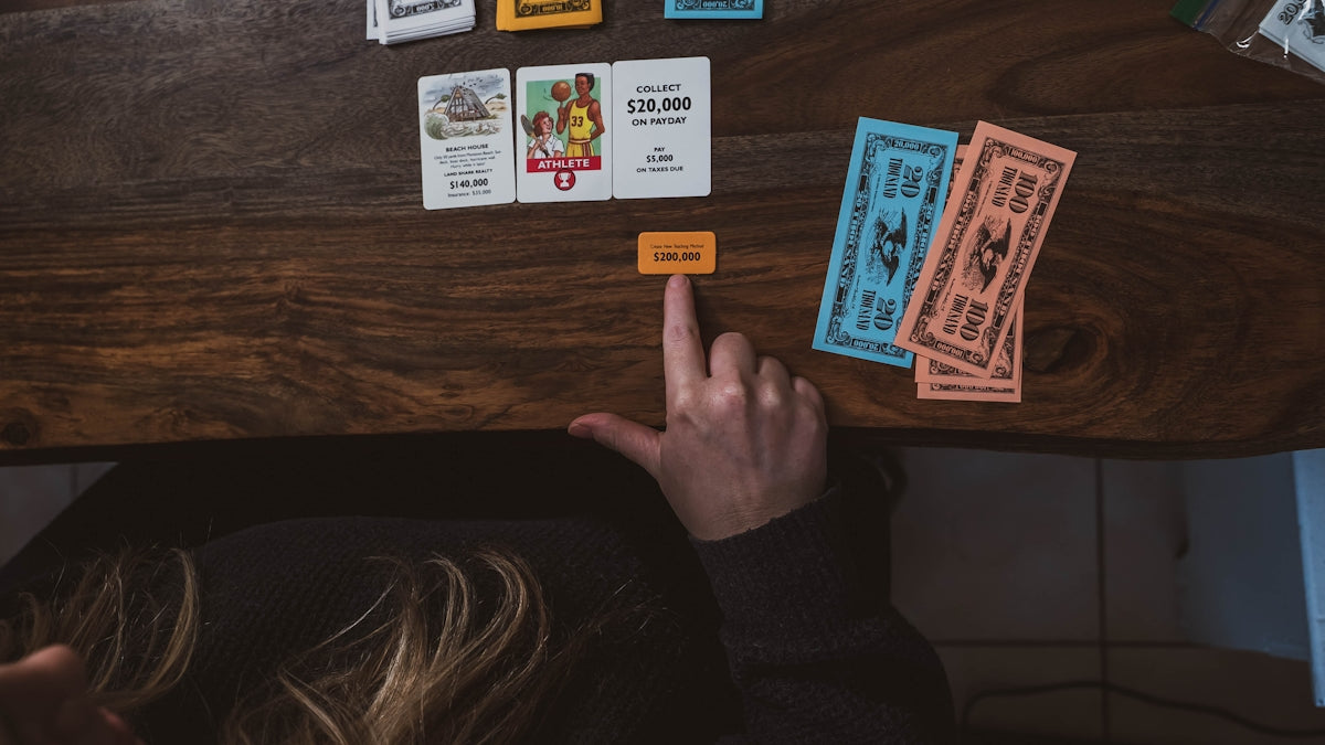 a person sitting at a table with some cards on it