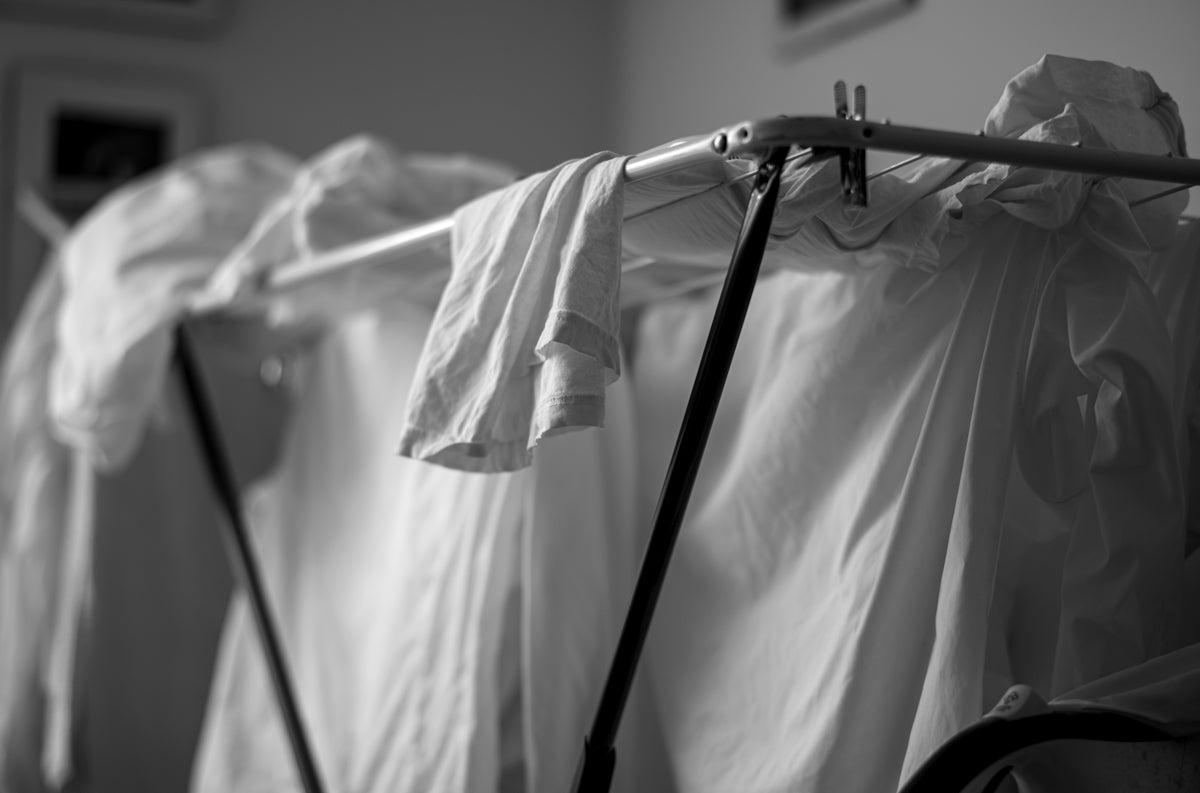 a black and white photo of clothes hanging on a clothesline