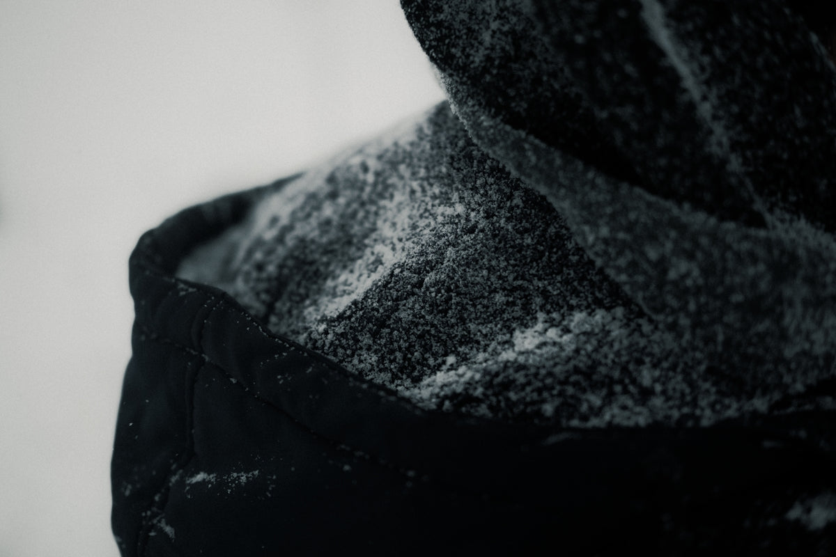 a close up of a person wearing a hooded jacket