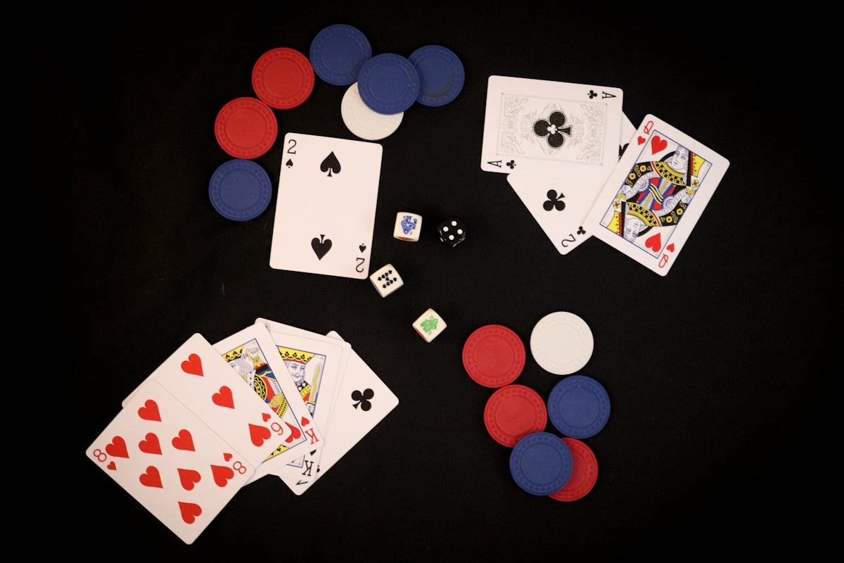 playing cards and dice on a black background