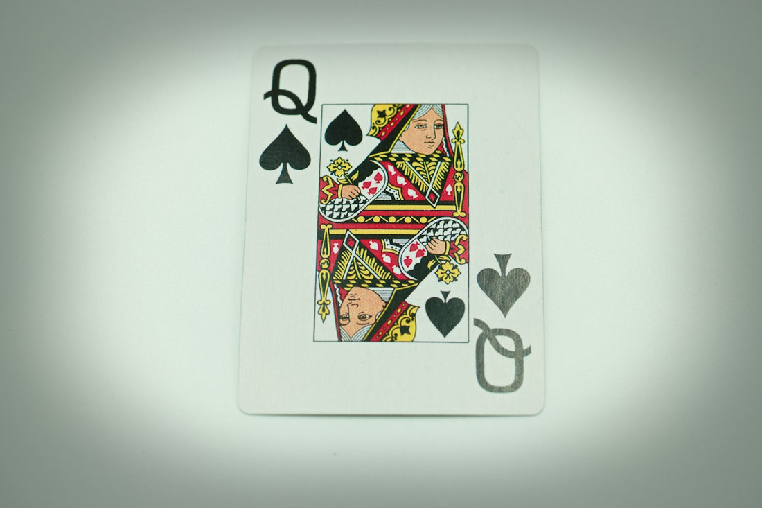 a playing card with a queen of spades on it