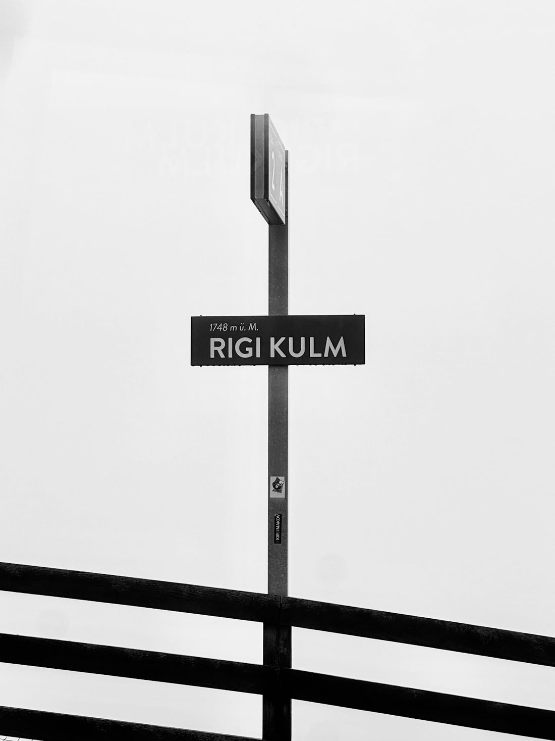 a black and white photo of a street sign