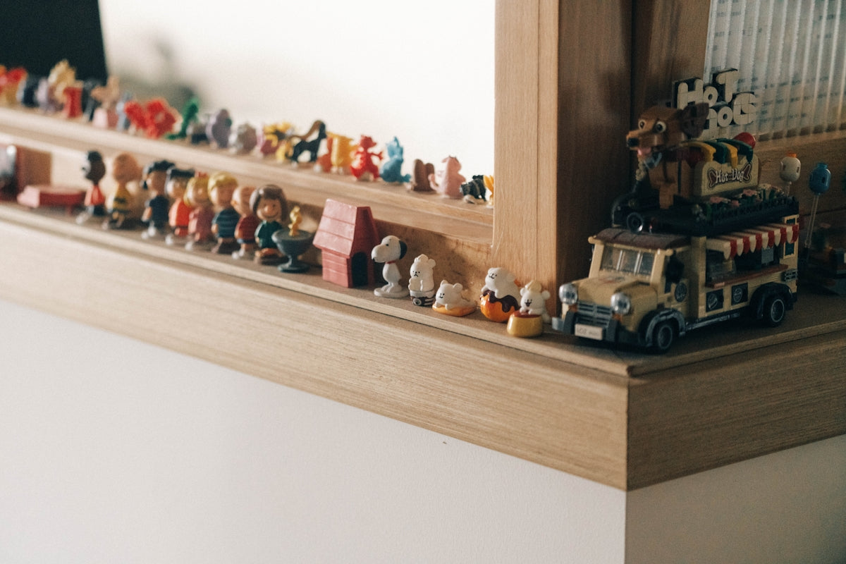 A shelf with a bunch of toy cars on top of it