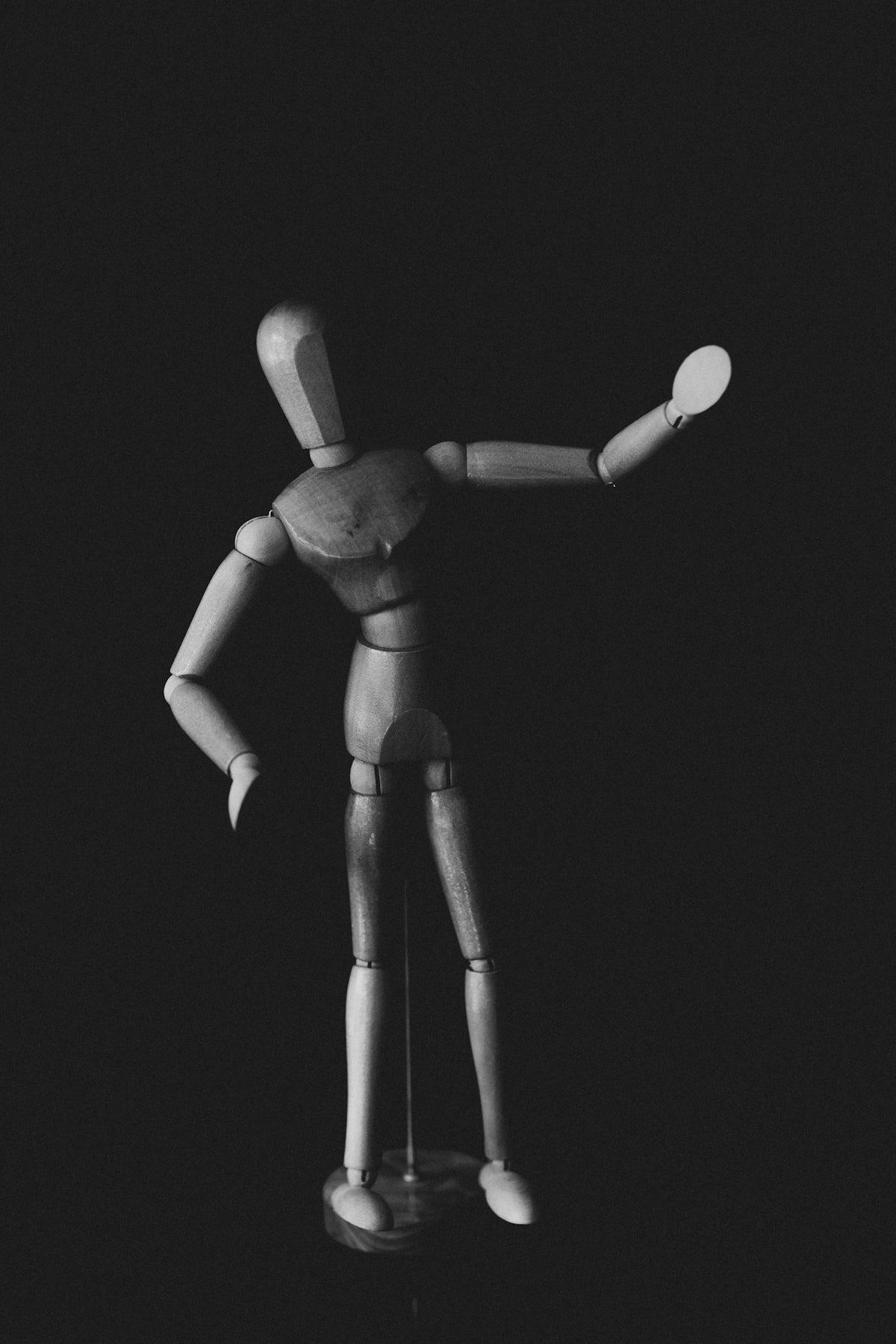 A black and white photo of a wooden figure