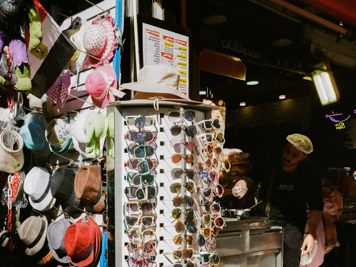 A man standing in front of a display of hats