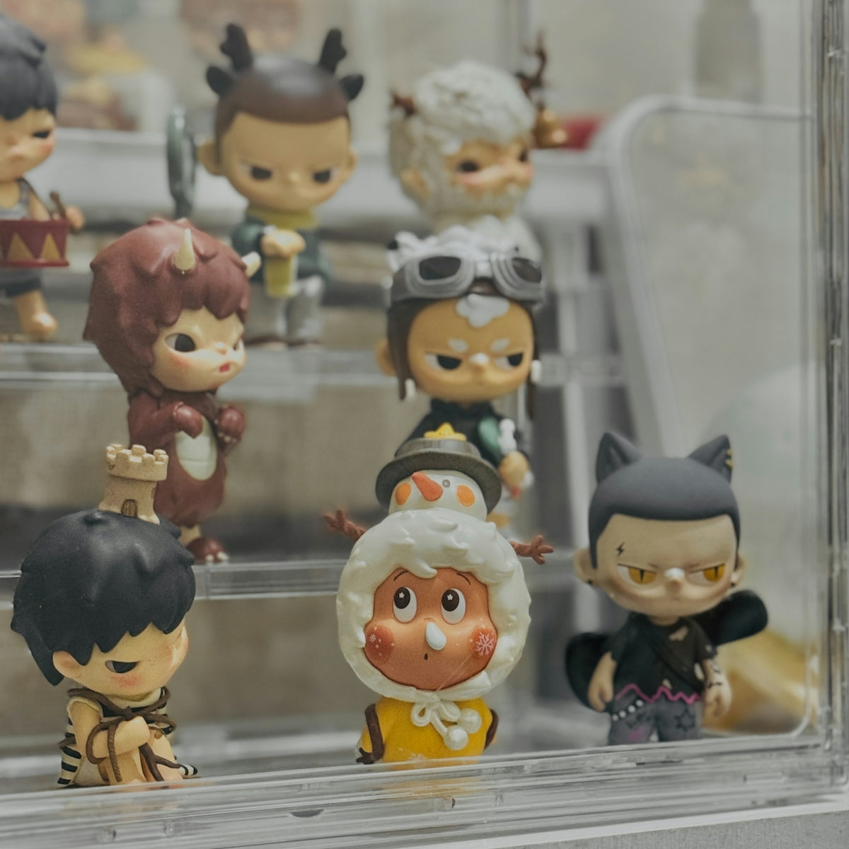 A bunch of small figurines in a display case