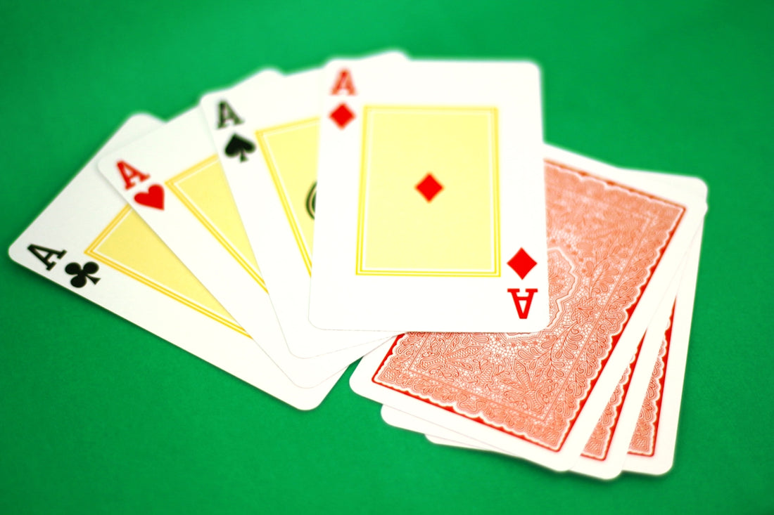 Four of a kind of playing cards on a green table