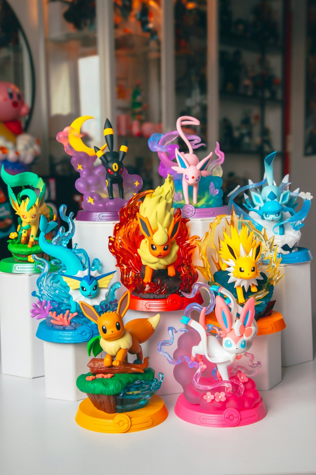 Various pokémon eeveelution figurines are displayed.
