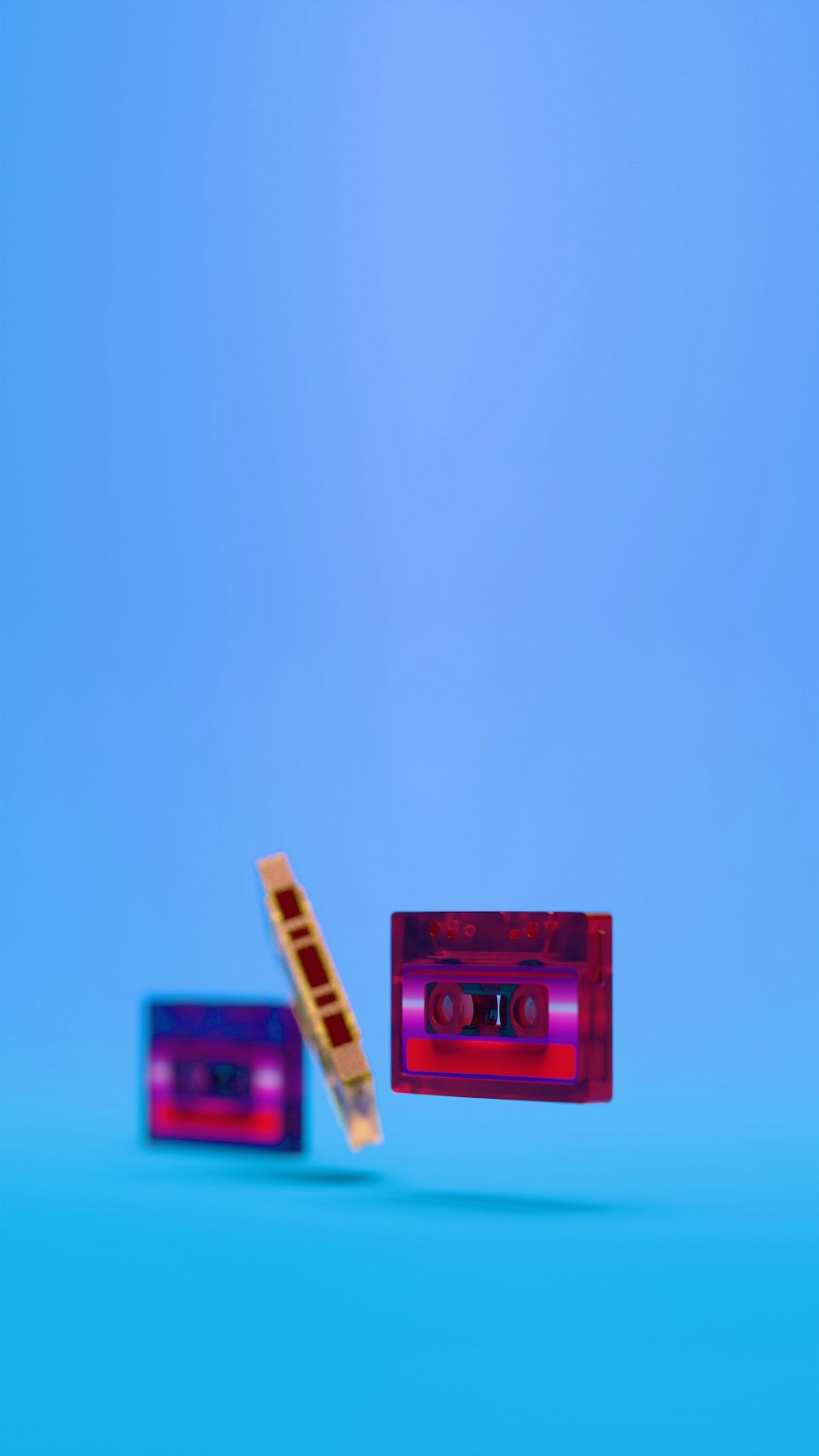 Cassette tapes floating on a vibrant blue background.