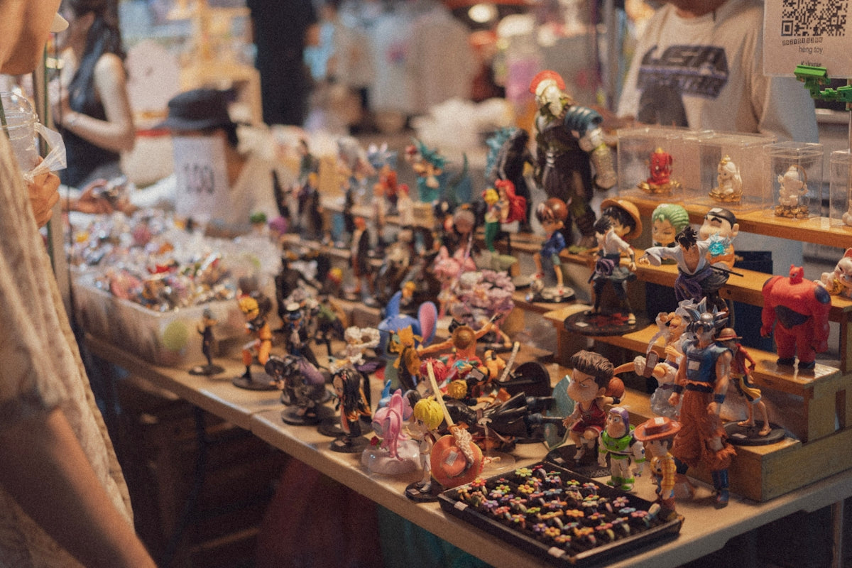 Display table filled with assorted collectible figurines.