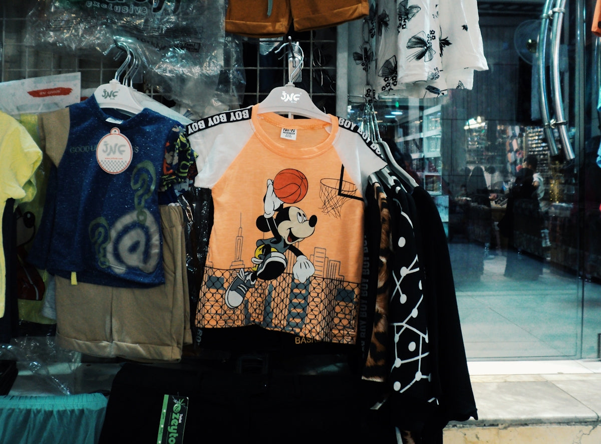 Children's clothes displayed in a store window.
