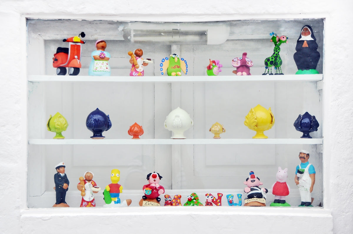 Collection of colorful figurines displayed on shelves