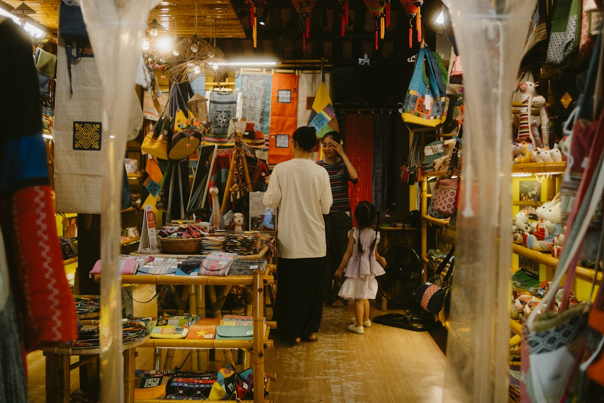 People browsing a shop filled with colorful merchandise.