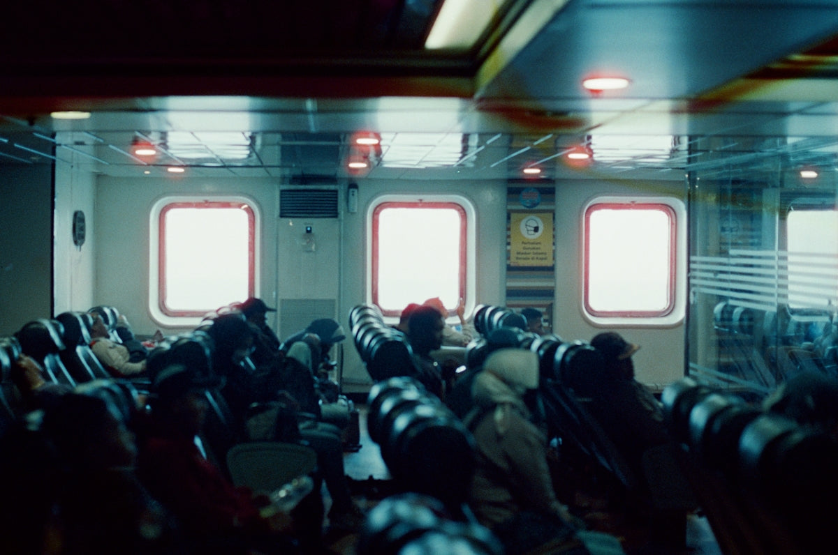 People with cameras in a dimly lit room