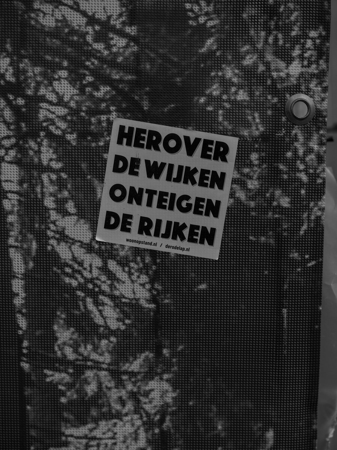 Sign with dutch text on a textured background