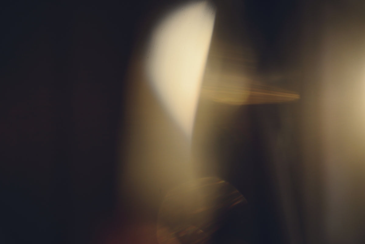 Abstract golden light flares on dark background