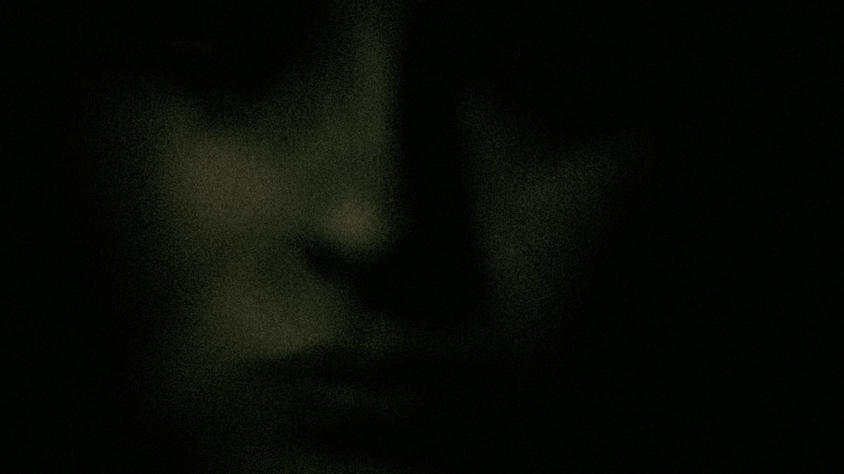 Close-up of a person's face in shadow