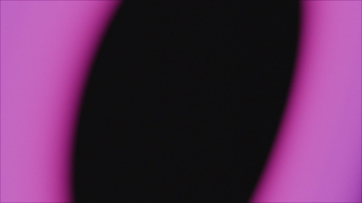 A black shape against a pink background