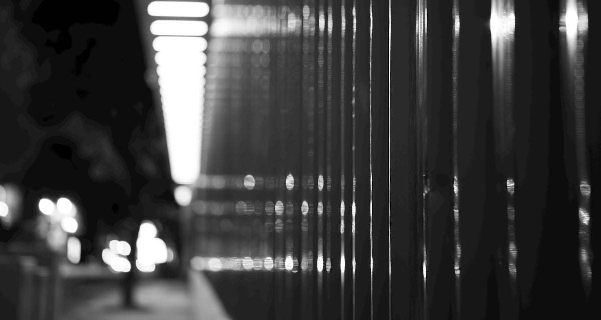Abstract black and white vertical lines with bokeh effect.