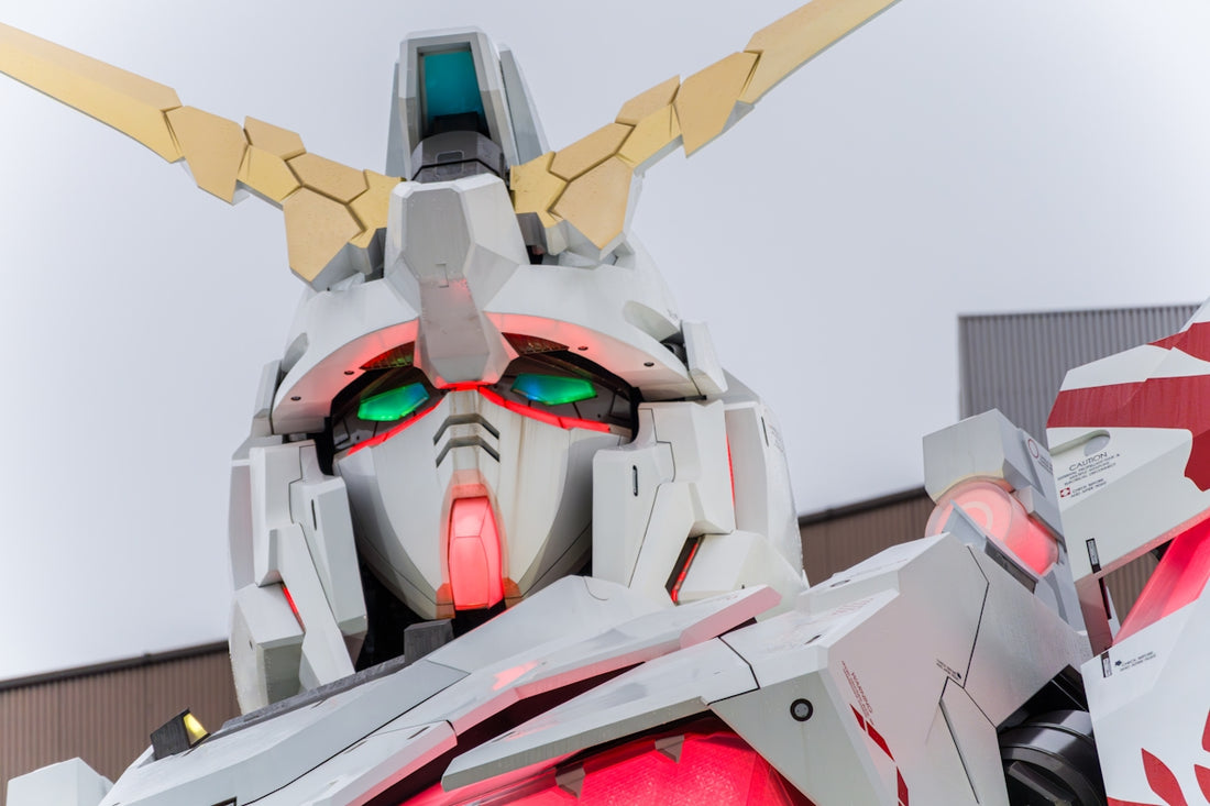 Gundam robot head with glowing green eyes and red accents.